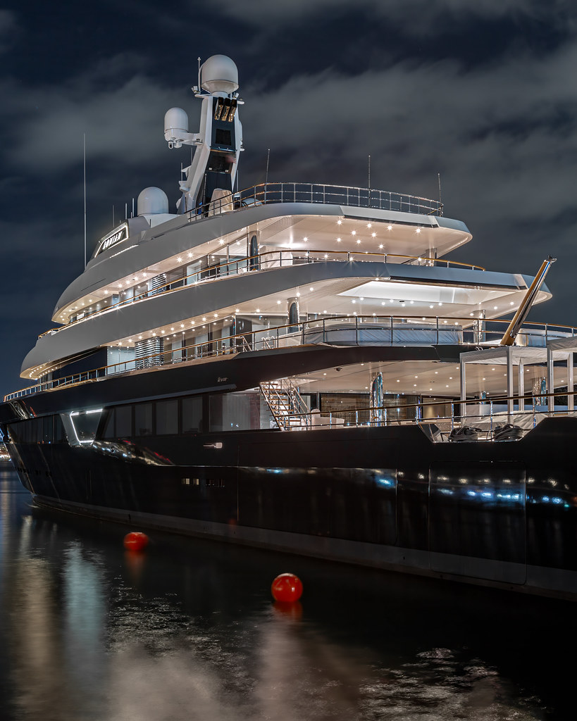 Lonian at night in San Diego, her dark hull and illuminated white superstructure visible close to the quay.