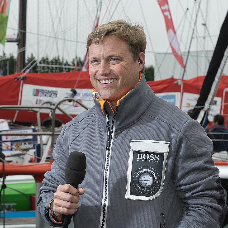 Alex Thomson holding a microphone before the 2012–13 Vendée Globe.